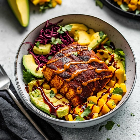 A bowl of food with a fork and knife.