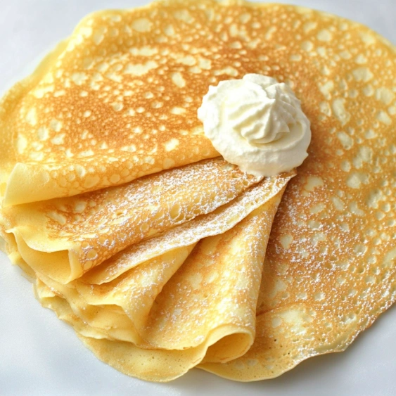 A white plate with a cream filled pastry.