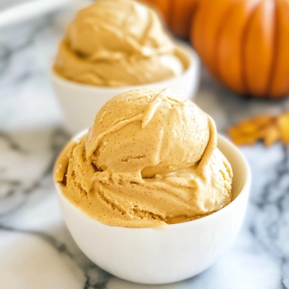 Two bowls of ice cream with pumpkin seeds.