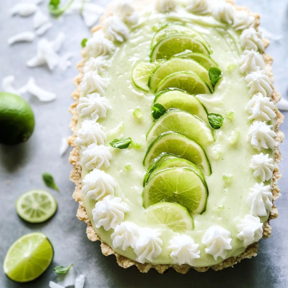 A slice of pie with lime slices on top.