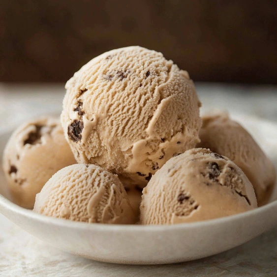 A bowl of ice cream with chocolate chips.